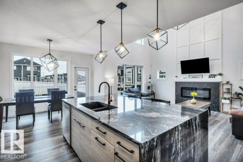 560 Stout Bend, Leduc, AB - Indoor Photo Showing Kitchen With Fireplace With Double Sink With Upgraded Kitchen