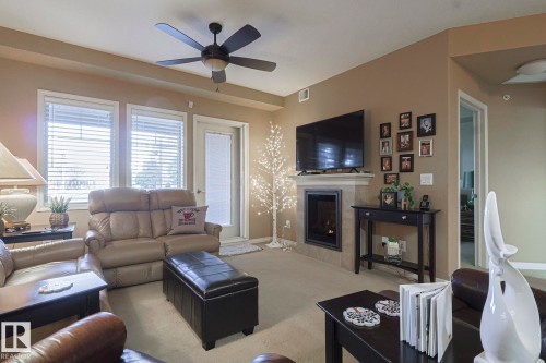 116 4450 Mccrae Avenue Nw, Edmonton, AB - Indoor Photo Showing Living Room With Fireplace