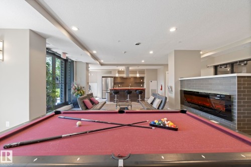 213 11080 Ellerslie Road, Edmonton, AB - Indoor Photo Showing Other Room With Fireplace