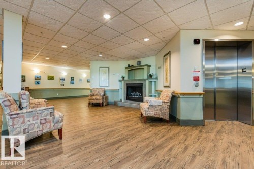 208 8802 Southfort Drive, Fort Saskatchewan, AB - Indoor Photo Showing Other Room With Fireplace