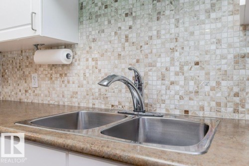 208 8802 Southfort Drive, Fort Saskatchewan, AB - Indoor Photo Showing Kitchen With Double Sink