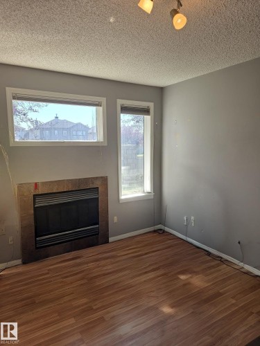 11 6304 Sandin Way, Edmonton, AB - Indoor Photo Showing Living Room With Fireplace