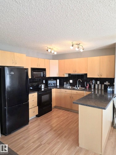 11 6304 Sandin Way, Edmonton, AB - Indoor Photo Showing Kitchen With Double Sink