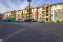 View of apartment building / complex featuring uncovered parking - 201 5804 Mullen Place, Edmonton, AB  - Outdoor With Balcony With Facade 