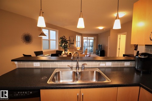 200 9940 Sherridon Drive, Fort Saskatchewan, AB - Indoor Photo Showing Kitchen With Double Sink