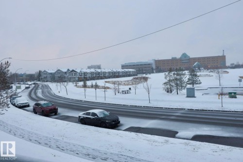 View of asphalt road featuring street lights - 213 5065 31 Avenue, Edmonton, AB - Outdoor With View