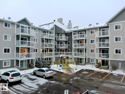View of apartment building / complex with uncovered parking - 213 5065 31 Avenue, Edmonton, AB - Outdoor With Balcony With Facade
