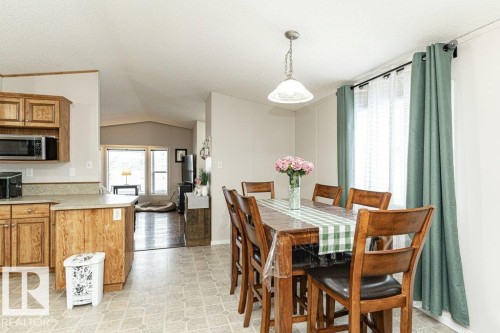 Dining room featuring lofted ceiling and a textured ceiling - 1637 68 Avenue, Edmonton, AB - Indoor Photo Showing Dining Room