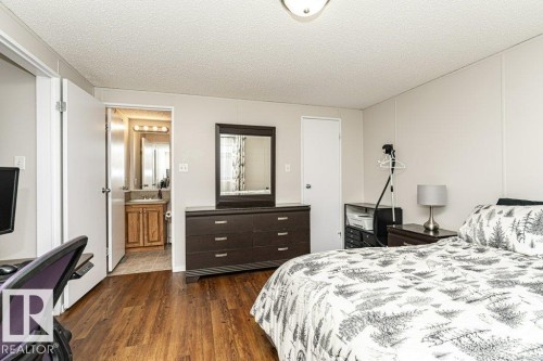Bedroom featuring dark wood-style floors and a textured ceiling - 1637 68 Avenue, Edmonton, AB - Indoor Photo Showing Bedroom