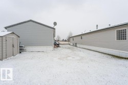 View of property exterior featuring a storage shed - 
