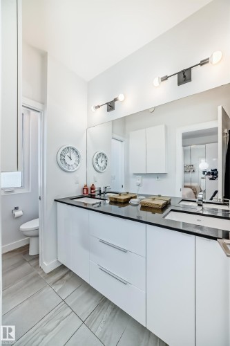 Full bathroom with connected bathroom, double vanity, and light tile patterned floors - 14812 98 Avenue, Edmonton, AB - Indoor Photo Showing Bathroom