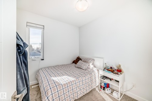 Bedroom with light colored carpet and baseboards - 14812 98 Avenue, Edmonton, AB - Indoor Photo Showing Bedroom