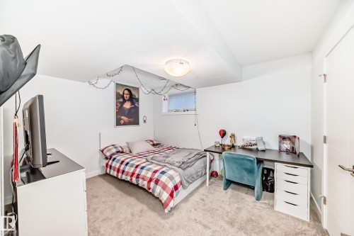 Bedroom featuring light colored carpet and an office area - 14812 98 Avenue, Edmonton, AB - Indoor Photo Showing Bedroom