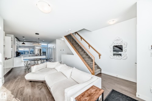 Living room featuring light wood finished floors and stairway - 14812 98 Avenue, Edmonton, AB - Indoor Photo Showing Living Room