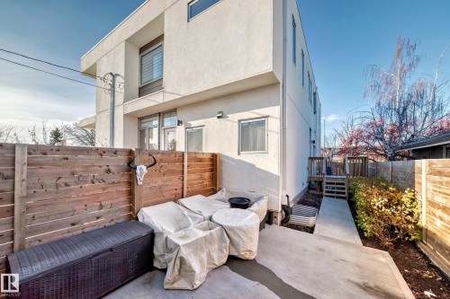 Back of property featuring stucco siding, a deck, and a patio area - 14812 98 Avenue, Edmonton, AB - Outdoor