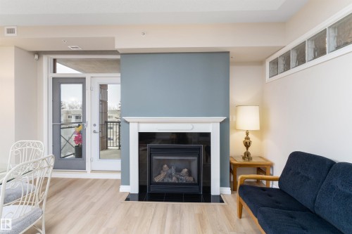 408 9020 Jasper Avenue, Edmonton, AB - Indoor Photo Showing Living Room With Fireplace