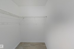 Spacious closet featuring light wood finished floors - 