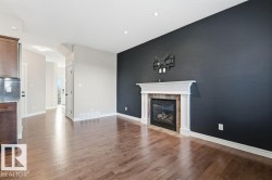 Unfurnished living room featuring light wood finished floors and a fireplace - 