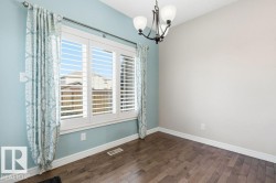 Empty room featuring a chandelier and wood-type flooring - 
