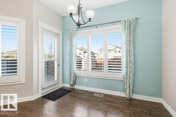 Entryway featuring a chandelier and wood-type flooring - 