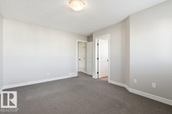 Unfurnished bedroom with a textured ceiling and carpet floors - 