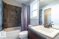 Full bathroom with shower / bathtub combination with curtain, vanity, a textured ceiling, and a spacious closet - 