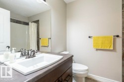 Full bathroom featuring vanity, curtained shower, a textured ceiling, and light tile patterned flooring - 