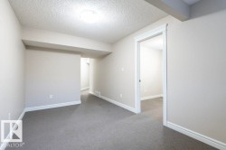 Carpeted empty room featuring a textured ceiling - 