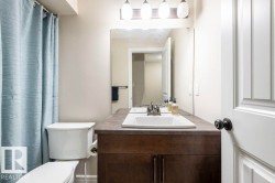 Bathroom featuring vanity and curtained shower - 