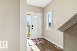 Foyer featuring baseboards and dark wood finished floors - 