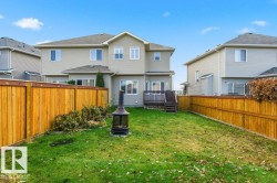 Back of property with a fenced backyard and a deck - 