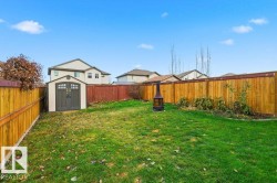 Fenced backyard with a storage shed - 