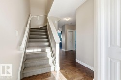 Stairway with wood finished floors and a textured ceiling - 