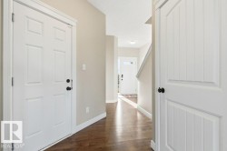 Foyer entrance featuring dark wood-style flooring and a textured ceiling - 