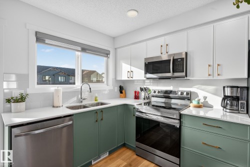 1174 Aster Boulevard, Edmonton, AB - Indoor Photo Showing Kitchen With Stainless Steel Kitchen With Double Sink