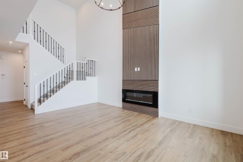 335 Bluff Cove, Leduc, AB - Indoor Photo Showing Other Room With Fireplace