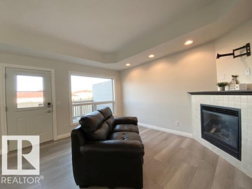 B 4706 57 Avenue, Wetaskiwin, AB - Indoor Photo Showing Living Room With Fireplace