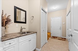 Bathroom with vanity, a textured ceiling, and a closet - 