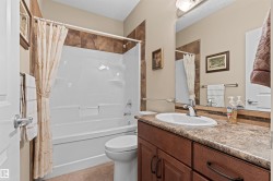 Bathroom featuring shower / bath combo, vanity, and light tile patterned flooring - 