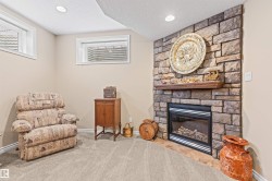 Sitting room with a textured ceiling, a fireplace, carpet, and recessed lighting - 