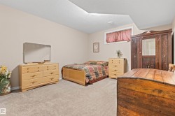 Bedroom with light colored carpet and a textured ceiling - 