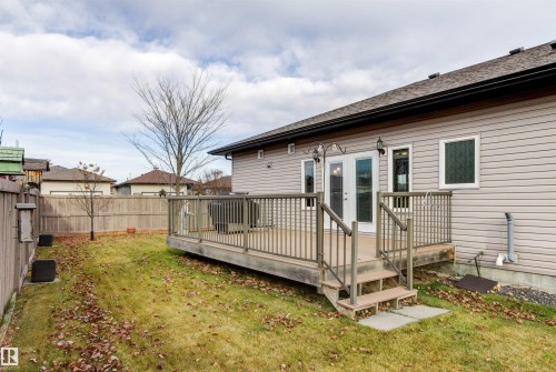 Rear view of property with a wooden deck, roof with shingles, and french doors - 50 Willow Wood Lane, Stony Plain, AB - Outdoor With Deck Patio Veranda