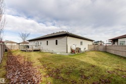 Rear view of property with a fenced backyard and a deck - 