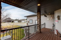 Deck featuring a residential view and a lawn - 