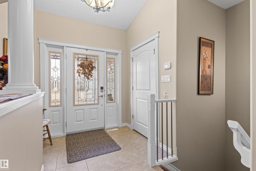 Entryway featuring light tile patterned flooring and a chandelier - 50 Willow Wood Lane, Stony Plain, AB - Indoor Photo Showing Other Room