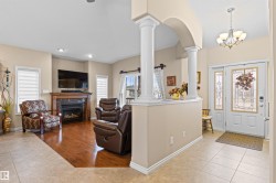 Entrance foyer featuring light tile patterned floors, plenty of natural light, a premium fireplace, and recessed lighting - 
