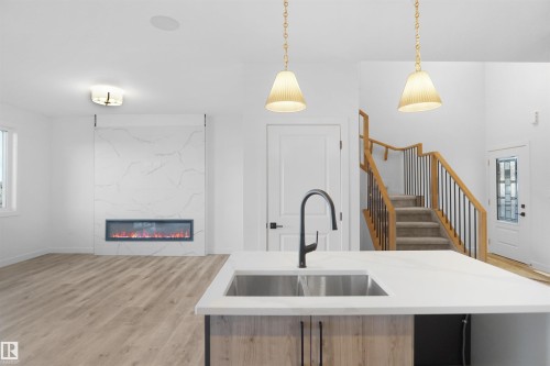 14 Axelwood Crescent, Spruce Grove, AB - Indoor Photo Showing Kitchen With Fireplace