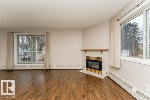 203 8503 108 Street, Edmonton, AB - Indoor Photo Showing Living Room With Fireplace
