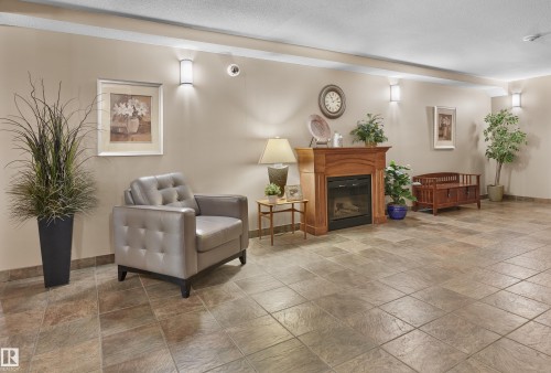 114 278 Suder Greens Drive, Edmonton, AB - Indoor Photo Showing Other Room With Fireplace