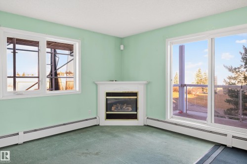 301 10511 42 Avenue, Edmonton, AB - Indoor Photo Showing Living Room With Fireplace